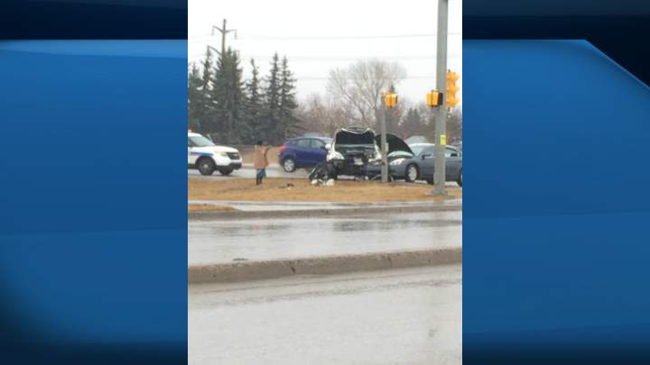 A man in apparent medical distress was involved in a two-vehicle collision where the male driver struck another vehicle, pushing it into a pedestrian light. 