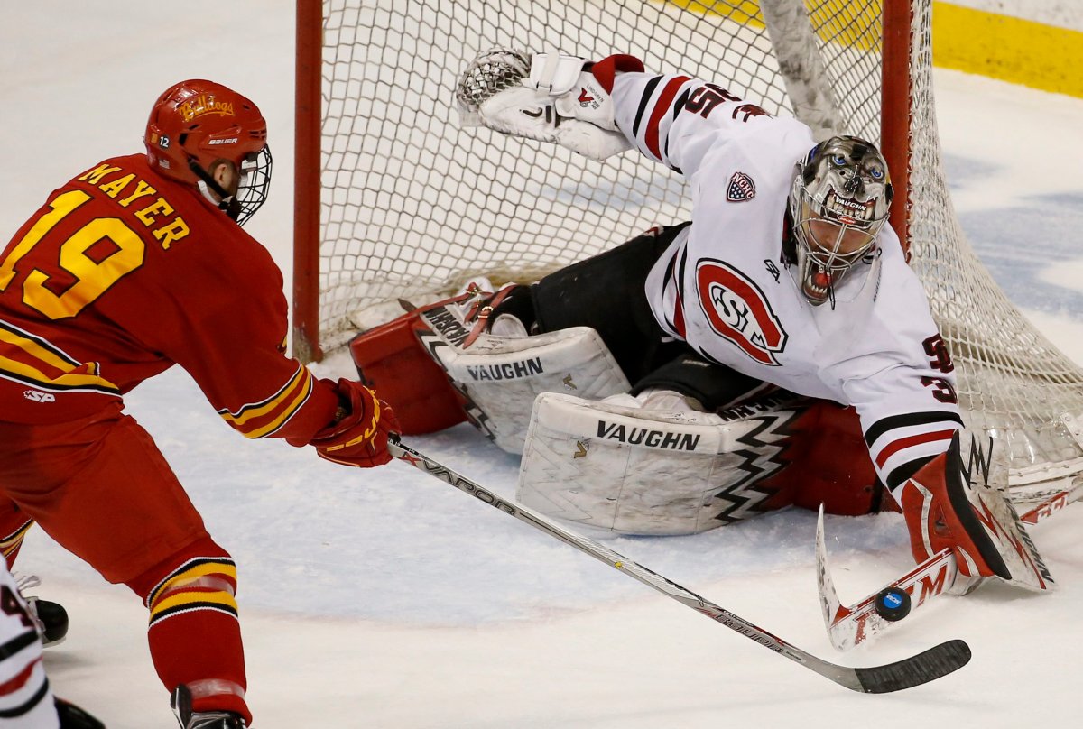 St. Cloud State goalie Charlie Lindgren (35) swats at a shot by Ferris State forward Andrew Mayer (19) during the first period of an NCAA men's hockey West Regional semifinal game in St. Paul, Minn., Saturday, March 26, 2016.