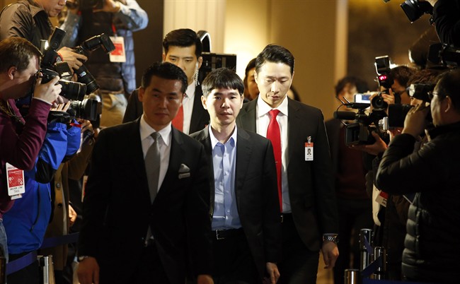 South Korean professional Go player Lee Sedol, center, arrives for the fourth match of the Google DeepMind Challenge Match against Google's artificial intelligence program, AlphaGo, in Seoul, South Korea, Sunday, March 13, 2016. Google's Go-playing software defeated a human champion for the third straight time Saturday to clinch the best-of-five series and establish its superiority in an ancient Chinese chess-like game long thought to be the realm of humans.