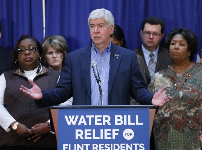 In this Feb. 26, 2016 photo, Gov. Rick Snyder speaks after attending a Flint Water Interagency Coordinating Committee meeting in Flint, Mich. The state of Michigan restricted Flint from switching water sources last April unless it got approval from Gov. Rick Snyder's administration under the terms of a $7 million loan needed to help transition the city from state management, according to a document released Wednesday, March 2, 2016.