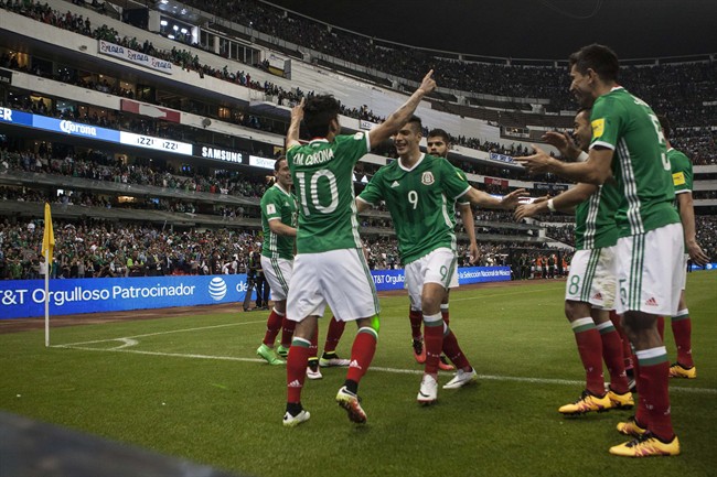 Mexico's Jesus Corona (10) celebrates his goal against Canada with teammate Raul Jimenez (9) during a World Cup qualifying soccer match in Mexico City, Tuesday, March 29, 2016.