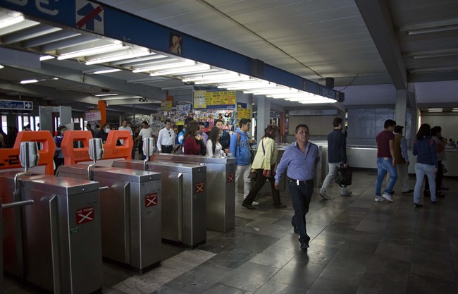 Passengers enter the Tasquena metro station in Mexico City, Wednesday, March 16, 2016. Authorities have banned more than 1 million cars from the roads and offered free subway and bus rides to coax people from their vehicles as Mexico City's first air pollution alert in 11 years stretched into a third day.