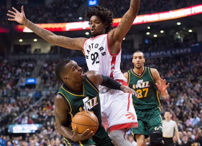 Toronto Raptors centre Lucas Nogueira (92) defends against Utah Jazz guard Shelvin Mack (8) during first half NBA basketball action in Toronto on Wednesday, March 2, 2016. THE CANADIAN PRESS/Nathan Denette.