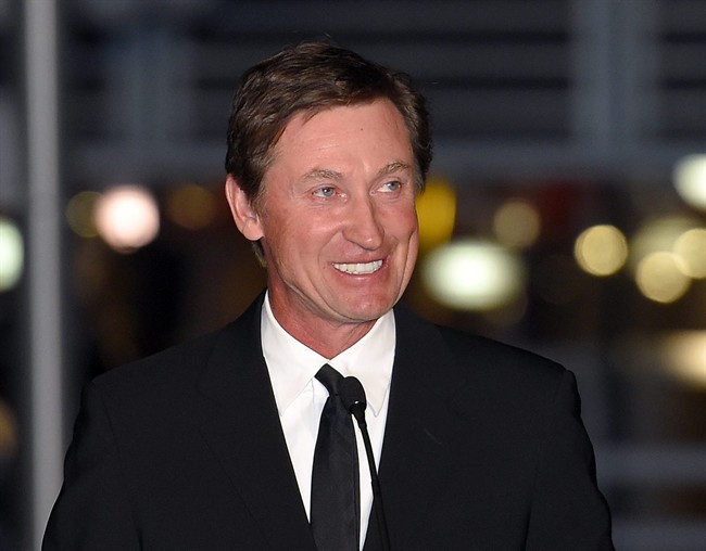  In this March 7, 2015 file photo, former Kings player Wayne Gretzky speaks to the crowd at a statue unveiling for former Kings left wing Luc Robitaille prior to an NHL hockey game against the Pittsburgh Penguins in Los Angeles. Gretzky, the NHL’s all-time scoring champion, has a deal with G.P. Putnam’s Sons for a book about the game’s history and his own place in it.