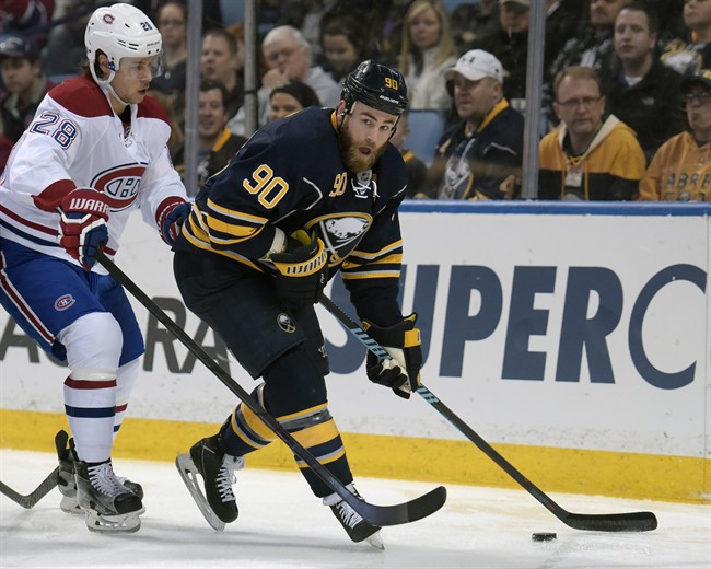 Montreal Canadiens defenseman Nathan Beaulieu (28) chases Buffalo Sabres center Ryan O'Reilly (90) as he looks to pass the puck during the first period of an NHL hockey game, Wednesday, March 16, 2016, in Buffalo, N.Y.