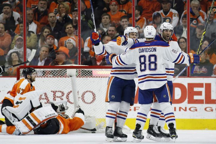 From right to left, Edmonton Oilers' Patrick Maroon, Brandon Davidson and Taylor Hall celebrate after Maroon's goal against Philadelphia Flyers' Michal Neuvirth and Andrew MacDonald during the second period of an NHL hockey game, Thursday, March 3, 2016, in Philadelphia. 