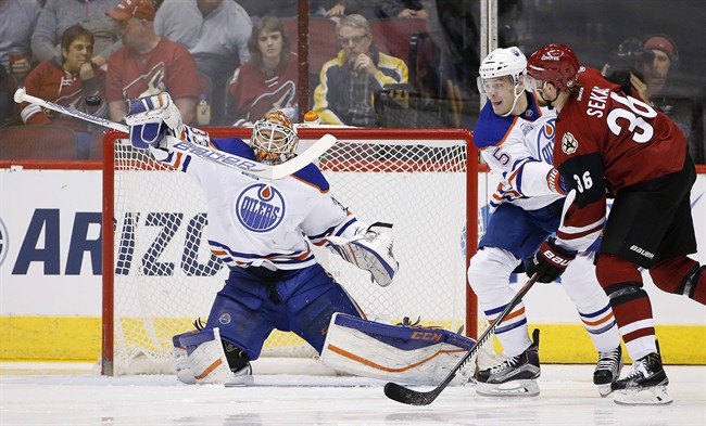 Edmonton Oilers' Cam Talbot, left, makes a save on a shot by Arizona Coyotes' Jiri Sekac, of the Czech Republic, as Oilers' Mark Fayne (5) defends during the first period of an NHL hockey game, Tuesday, March 22, 2016, in Glendale, Ariz. 