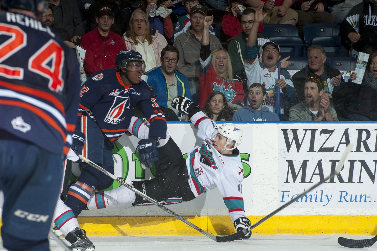  Jermaine Loewen of the Kamloops Blazers is checked by Jordan Borstmayer of the Kelowna Rockets on Saturday at Prospera Place. 