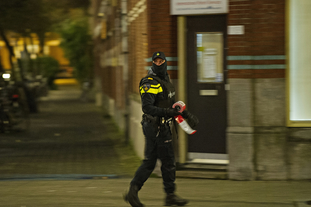 A policeman is at work near the place where a 32-year-old Frenchman was arrested at the request of French authorities over suspicsions of his "involvement in planning a terror attack", on March 27, 2016 in Amsterdam. 