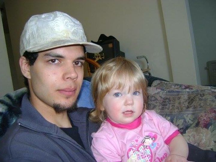 Ryan Lane is pictured holding his daughter when she was a toddler.