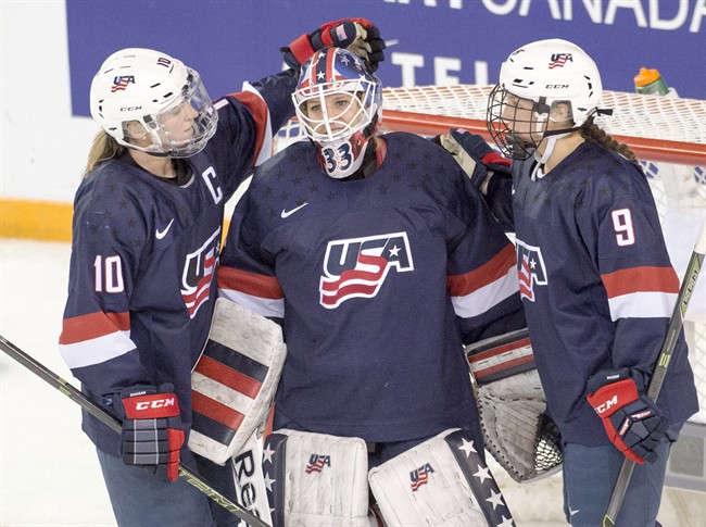 Team USA goaltender Alex Rigsby celebrates with teammates Meghan Duggan (10) and Megan Bozek (9) after defeating Canada 3-1 at the women's world hockey championships Monday, March 28, 2016 in Kamloops, B.C. 