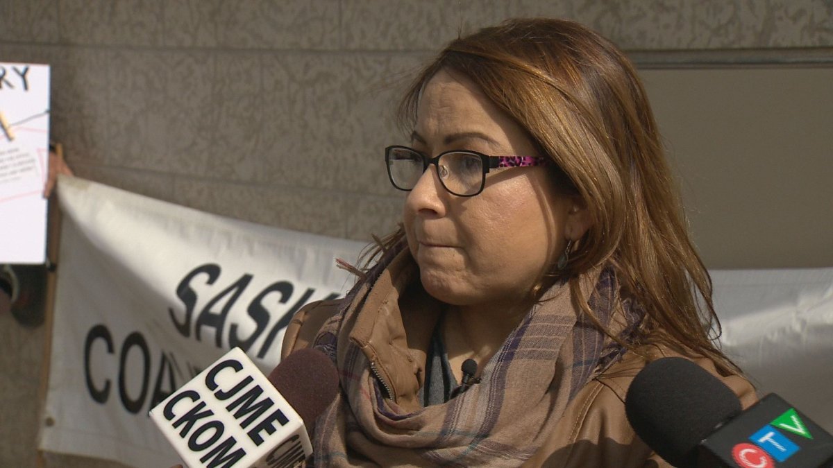 Suzanne Mayer protesting with the Saskatchewan Coalition Against Racism outside SGI HQ.