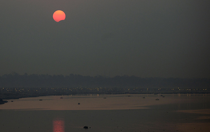 A partial solar eclipse is seen over Sangam, in Allahabad on March 9, 2016.