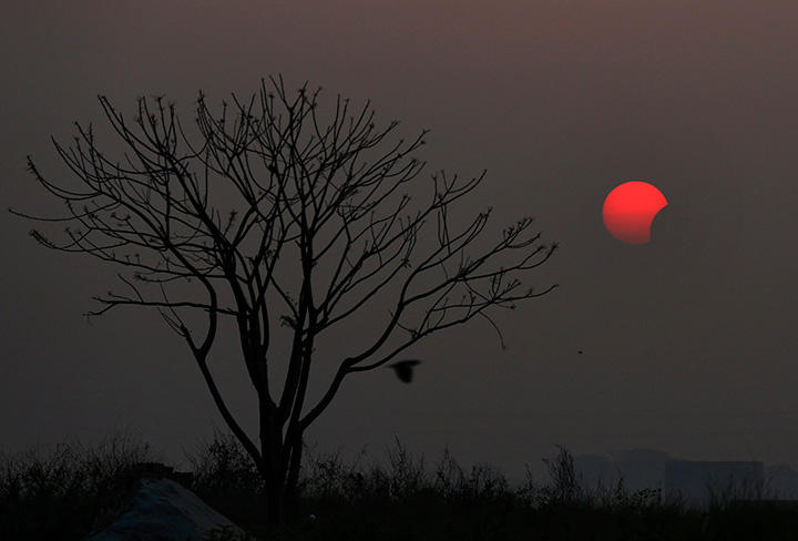A partial solar eclipse is seen from Dhaka, Bangladesh, Wednesday, March 9, 2016.