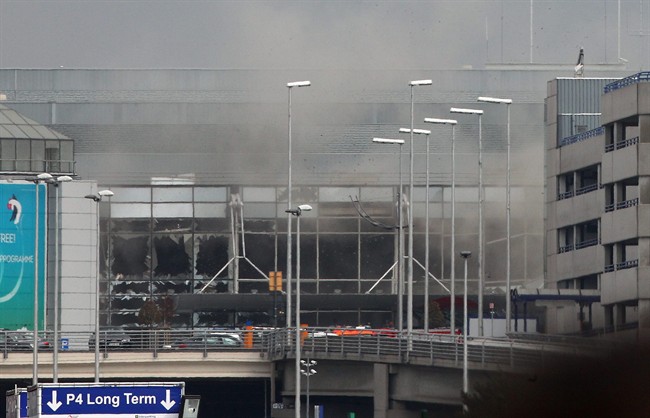 Smoke billows from the Zaventem Airport after a controlled explosion in Brussels, Tuesday. Bombs struck the Brussels airport and one of the city's metro stations Tuesday, killing and wounding dozens of people, as a European capital was again locked down amid heightened security threats.
