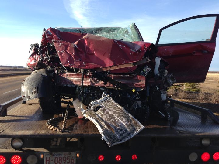 Woman in hospital after vehicle crashes through St. Albert sign