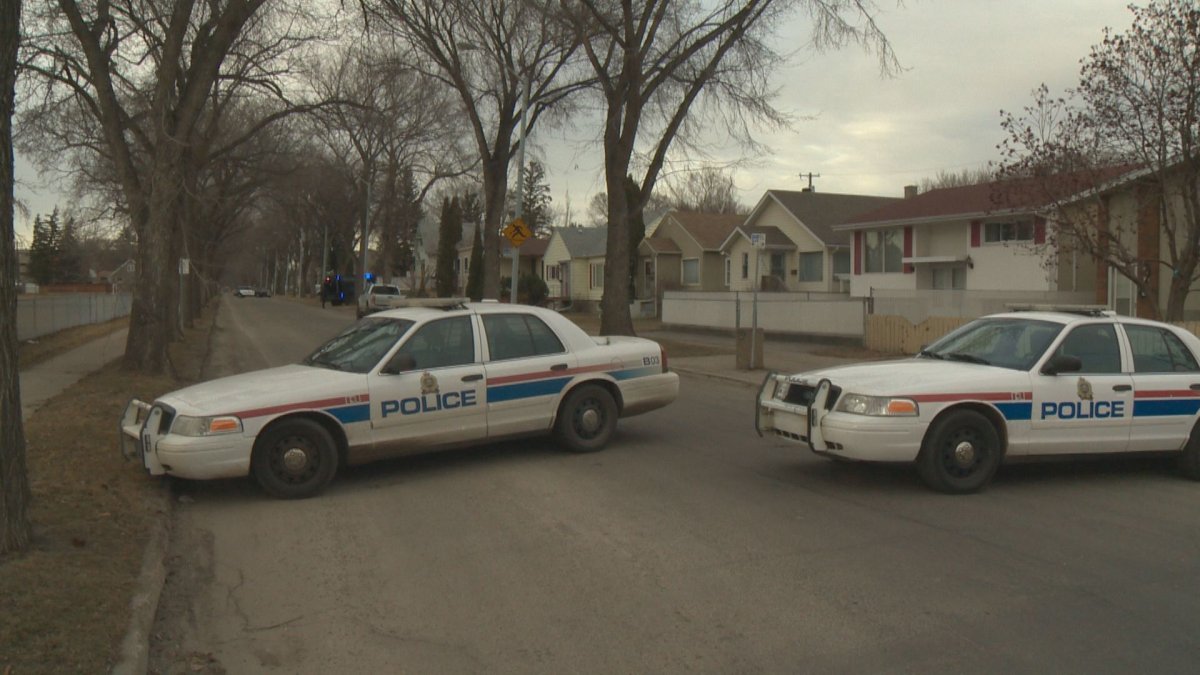 Police cars block off access to a street where officers spent nearly 11 hours on Saturday.