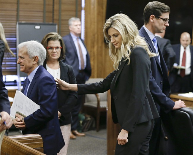 Sportscaster and television host Erin Andrews pats her attorney, Bruce Broillet, on the back after he finished his closing argument Friday, March 4, 2016, in Nashville, Tenn. Andrews has filed a $75 million lawsuit against the franchise owner and manager of a luxury hotel and a man who admitted to making secret nude recordings of her in 2008. The jury will begin deliberations Monday. 