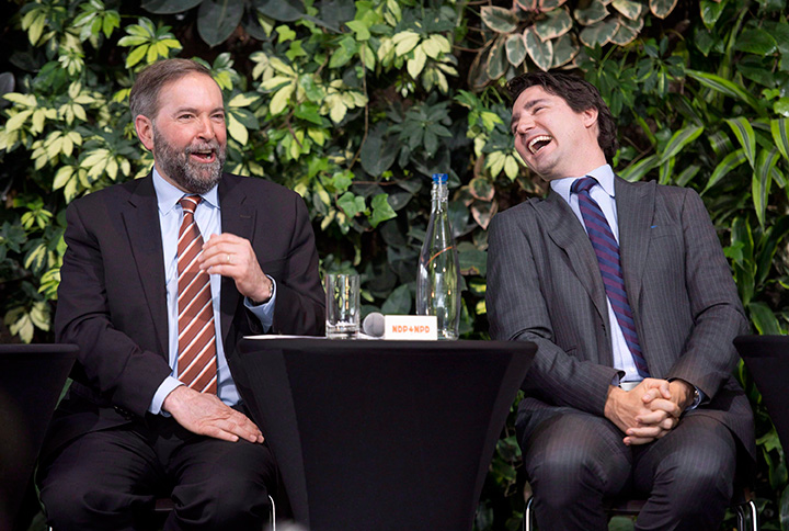Justin Trudeau laughs with NDP Leader Tom Mulcair as he speaks during a panel discussion on youth voting, Wednesday, March 26, 2014 in Ottawa. 