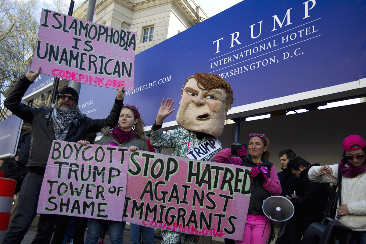 CodePink demonstrators protest outside of the Trump Hotel in Washington, Monday, March 21, 2016, as the Republican presidential candidate Donald Trump speaks inside. 