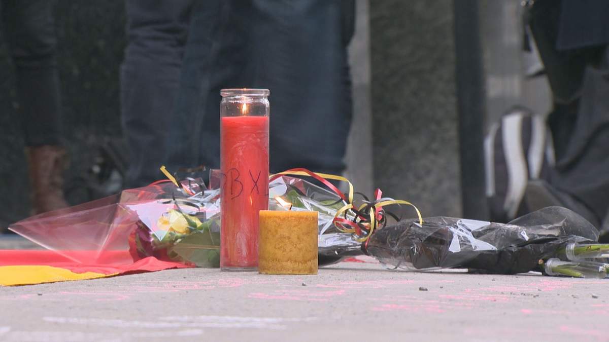 A candle burns for the victims of the Brussels attack, Wednesday, March 23, 2016.