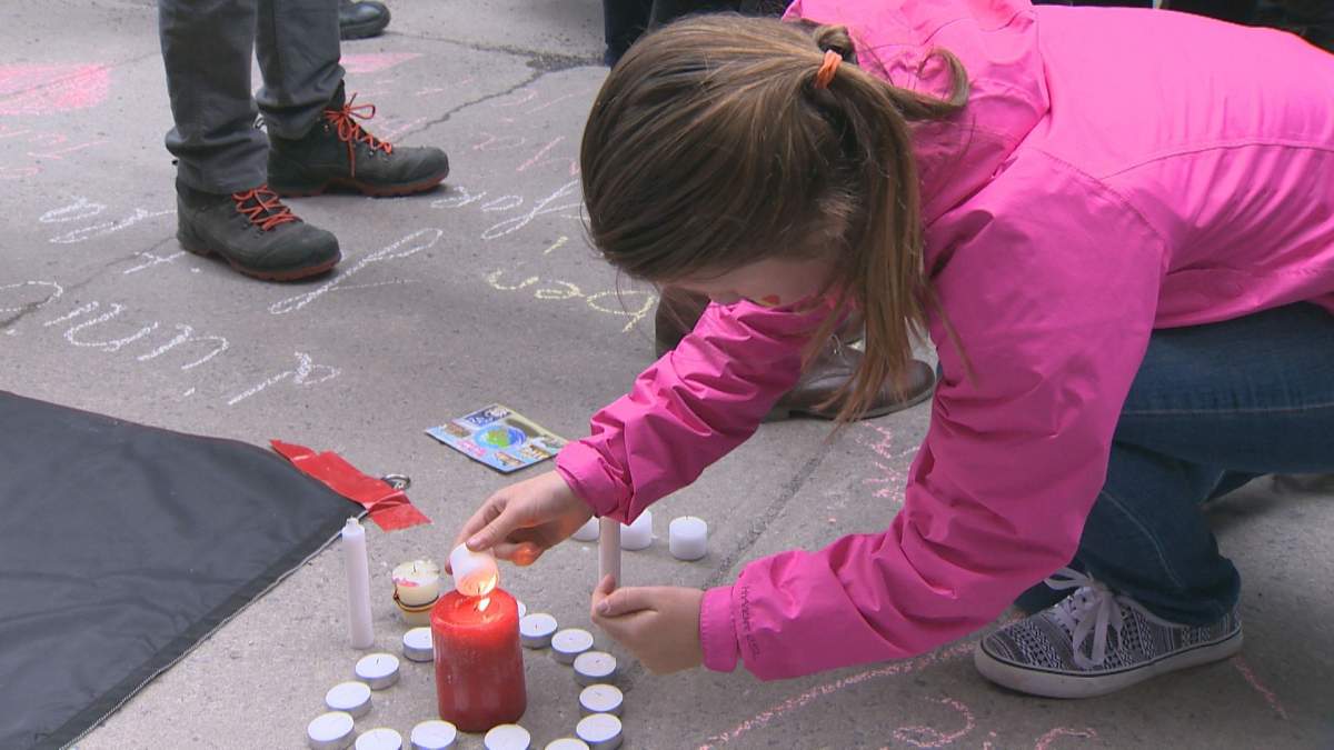 Montrealers light candles in memory of the victims of the Brussels attack, Wednesday, March 24, 2016.