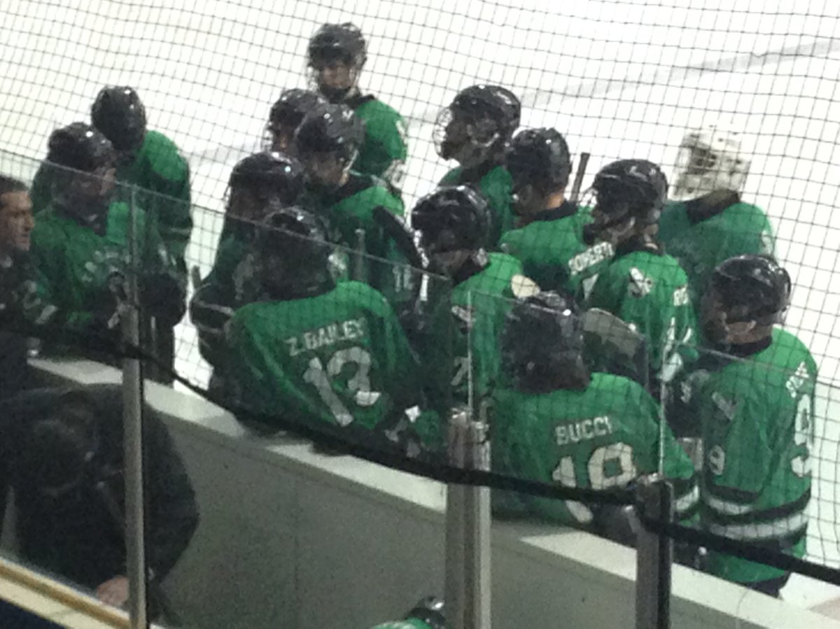 The Vincent Massey Trojans gather at the bench during a break in their game on Friday against the Dauphin Clippers.