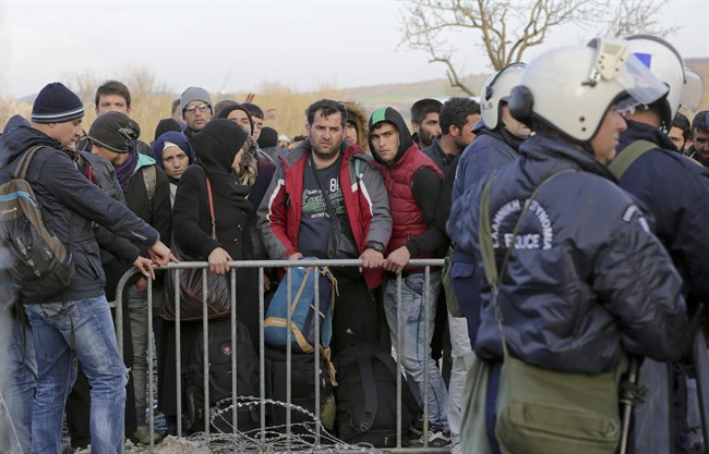 Stranded Syrian and Iraqi migrants wait to enter Macedonia from Greece near the southern Macedonian town of Gevgelija, Wednesday, March 2, 2016.