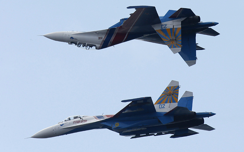 Russian SU-27 jets perform stunts during an air show at the International Maritime Defence show in St.Petersburg, Russia, Sunday, July 5, 2015. 