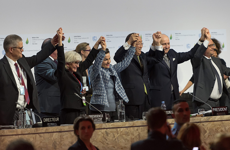 World leaders celebrating after reaching a climate agreement on December 12, 2015, in Paris.