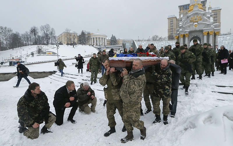 Ukrainian servicemen carry the coffin with the body of Oleksandr Ilnytsky, member of Police special battalion 'Myrotvorets' (Peacemaker) who was killed in the eastern Ukraine conflict, during the funeral ceremony on the Independence Square in Kiev, Ukraine, 11 January 2016.   