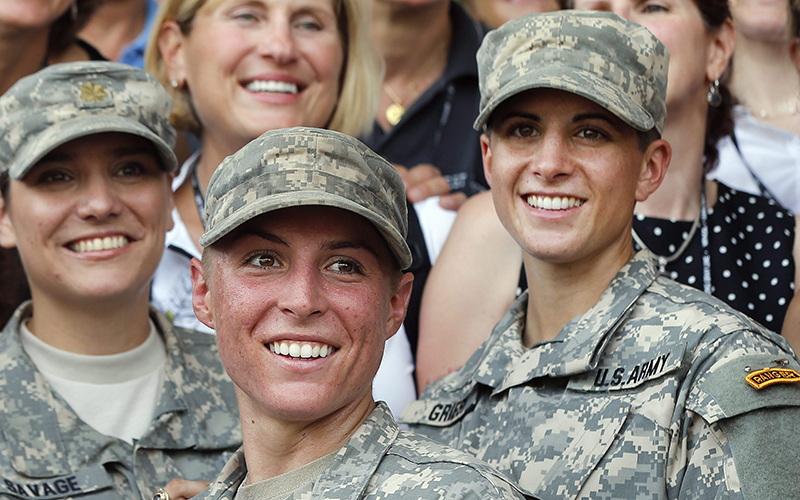 Army 1st Lt. Shaye Haver, center, and Capt. Kristen Griest, right, pose for photos with other female West Point alumni after an Army Ranger school graduation ceremony at Fort Benning, Ga. 