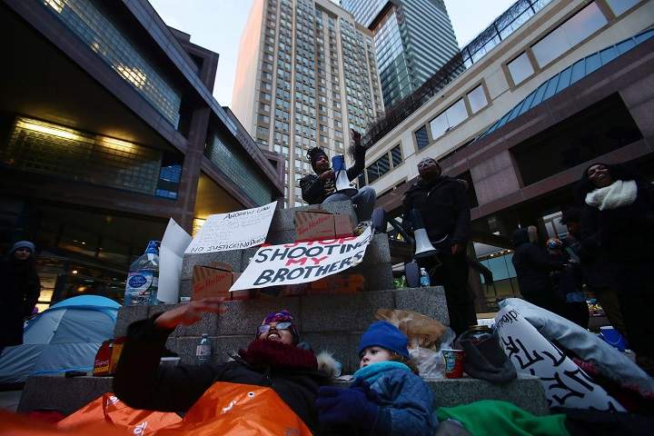 Protesters camp out front of the Toronto Police Headquarters in Toronto on Monday, March 21, 2016.
