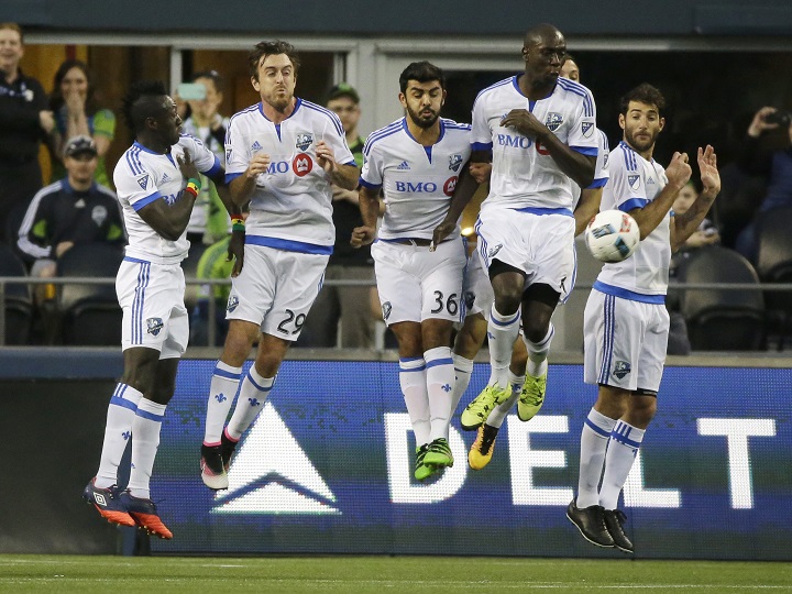 In this file photo, Montreal Impact players, including defender Victor Cabrera, center, midfielder Eric Alexander, second from left, and defender Hassoun Camara, second from right, form a wall to block a free kick by Seattle Sounders midfielder Clint Dempsey during the first half of an MLS soccer match, Saturday, April 2, 2016, in Seattle. 