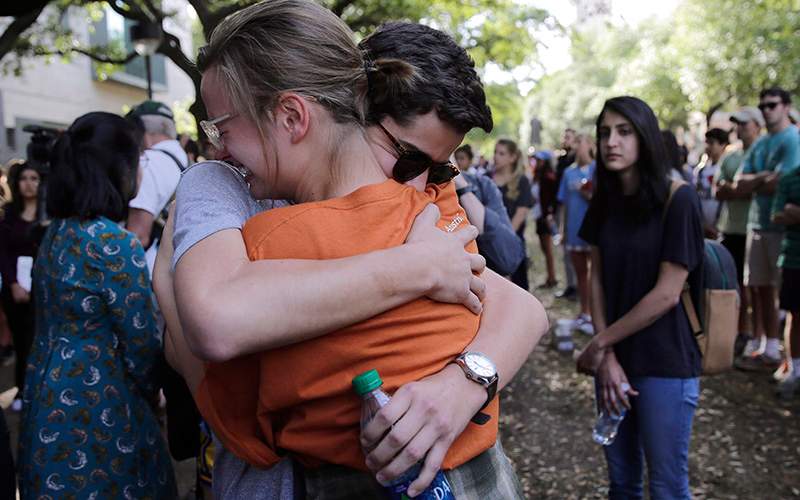 University of Texas students embrace during a gathering for fellow student Haruka Weiser on campus, Thursday, April 7, 2016, in Austin, Texas. Weiser, a first-year theater and dance student from Oregon, was found dead on campus after she was reporter missing earlier this week.