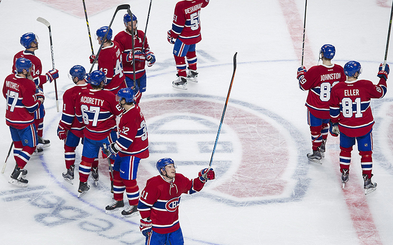 Montreal Canadiens players salute their fans following their win over the Tampa Bay Lightning in an NHL hockey game in Montreal, Saturday, April 9, 2016.