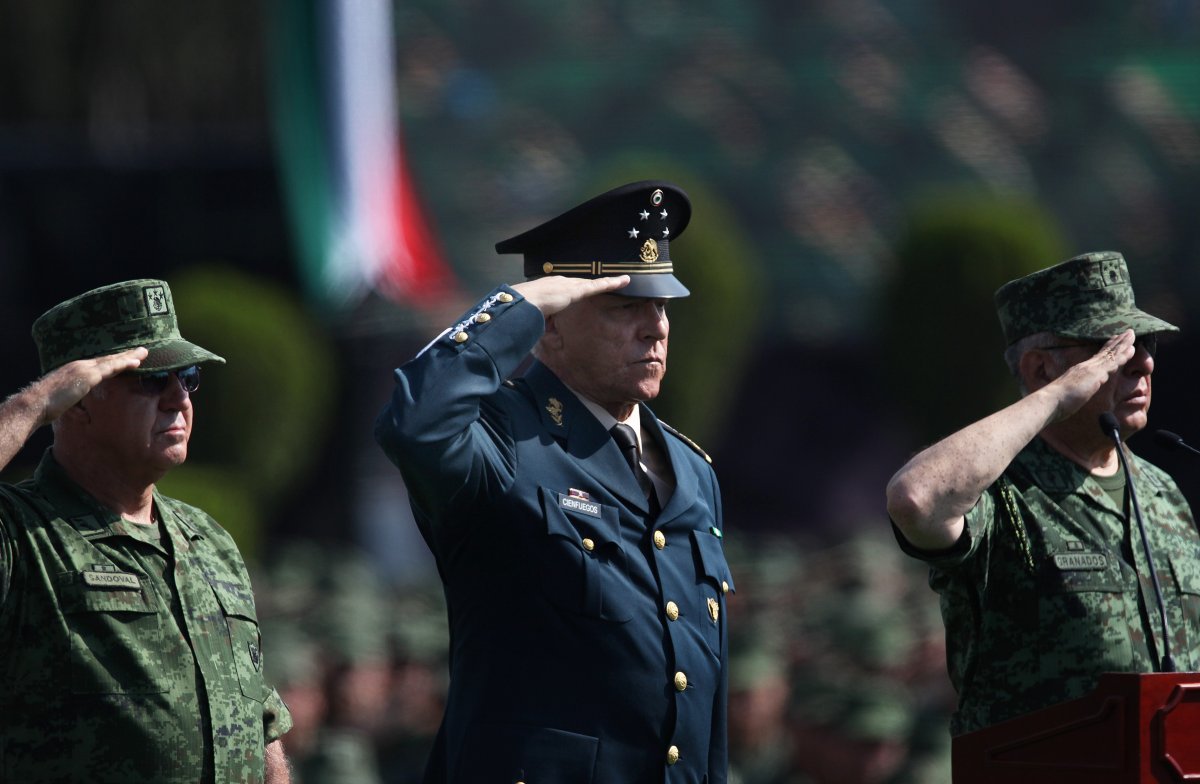 Mexico's Defense Secretary Gen. Salvador Cienfuegos Zepeda, center, salutes soldiers at the Number 1 military camp in Mexico City, Saturday, April 16, 2016. Cienfuegos formally apologized to the country for a video-recorded incident of torture involving two soldiers and a federal police officer. He urged soldiers and citizens to come forward to report other abuses.