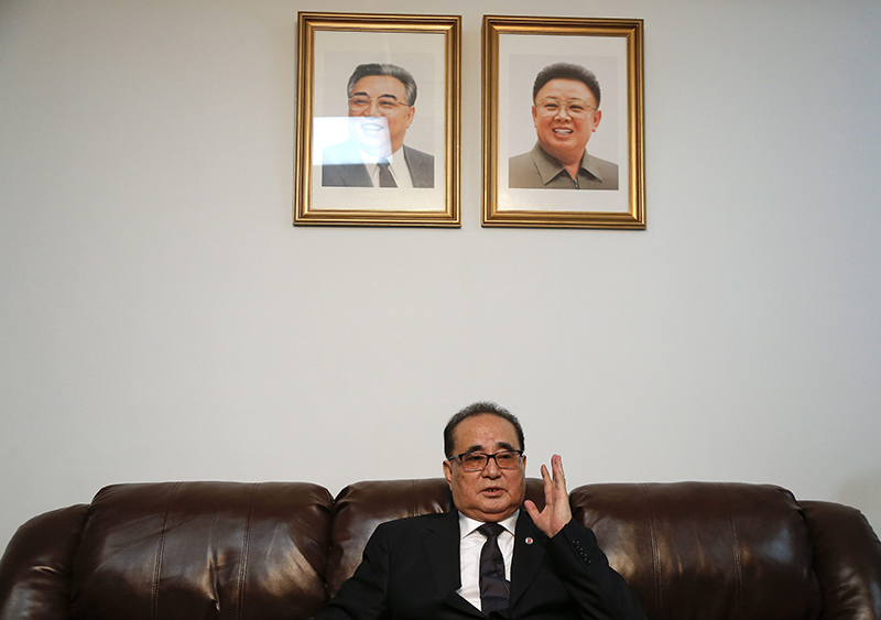 Seated under portraits of former North Korean Leaders Kim Il Sung, left, and Kim Jong Il, North Korea's Foreign Minister Ri Su Yong answers questions during an interview, Saturday, April 23, 2016, at the country's Permanent Mission to the United Nations in New York. 