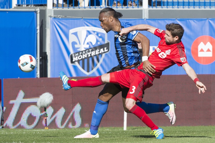 Toronto FC defender Drew Moor stretches to knock the ball away from Montreal Impact forward Didier Drogba during first half MLS action Saturday, April 23, 2016 in Montreal.