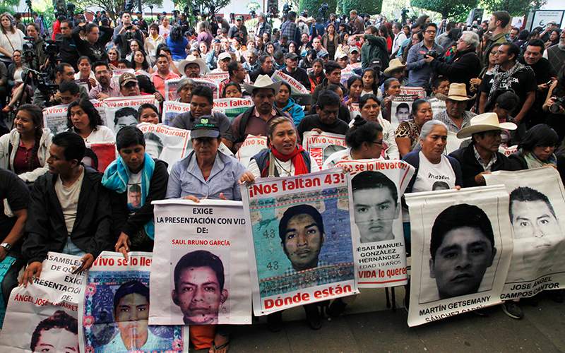 Relatives of the 43 missing students listen to the international experts group's report, in Mexico City, Sunday, April 24, 2016. 