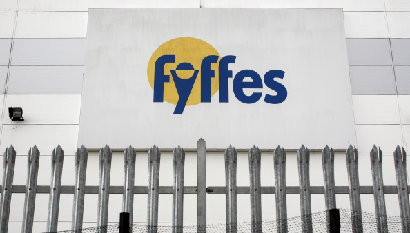 A Fyffes logo sits above metal security railings outside Fyffes Plc's banana ripening and fruit distribution plant in Coventry, U.K., on Thursday, Aug. 21, 2014.  