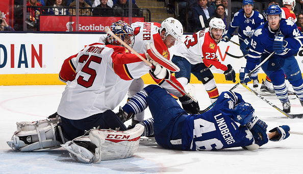 Steven Kampfer #3 of the Florida Panthers knocks down Tobias Lindberg #46 of the Toronto Maple Leafs in front of Al Montoya #35 of the Florida Panthers during game action on April 4, 2016 at Air Canada Centre in Toronto, Ontario, Canada. (Photo by Graig Abel/NHLI  via Getty Images).