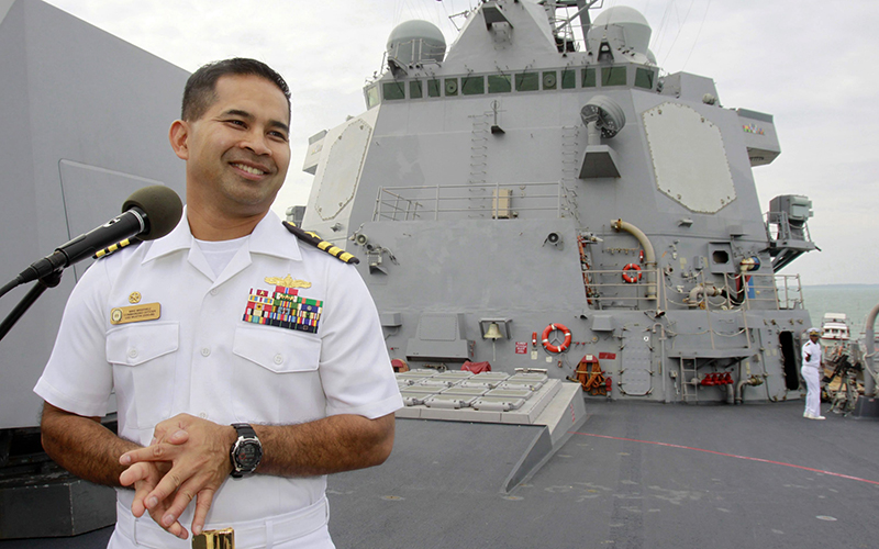 U.S. navy officer Michael "Vannak Khem" Misiewicz smiles as he delivers his welcome speech on the deck of the U.S. Navy destroyer USS Mustin at Cambodian coastal international see port of Sihanoukville, about  220 kilometers southwest of Phnom Penh, Cambodia. 