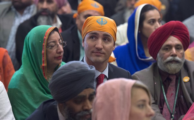 Prime Minister Justin Trudeau sits with members of the Sikh community and government caucus during a Vaisakhi Celebration on Parliament Hill in Ottawa, Monday April 11, 2016.