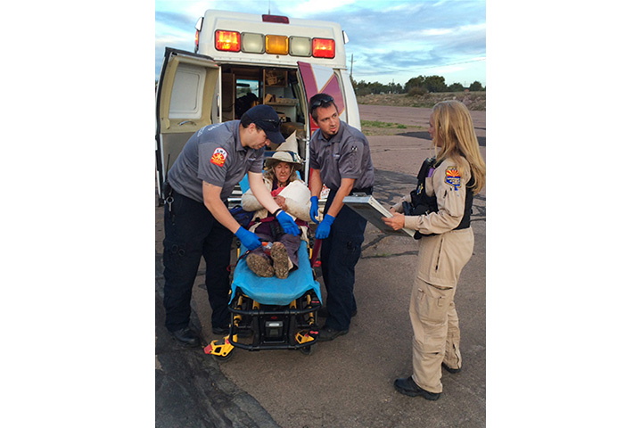 This photo taken, Saturday, April 9, 2016, and provided by Arizona Department of Public Safety shows an ambulance taking Ann Rodgers, 72, to safety after she was lost in the forest for nine days.