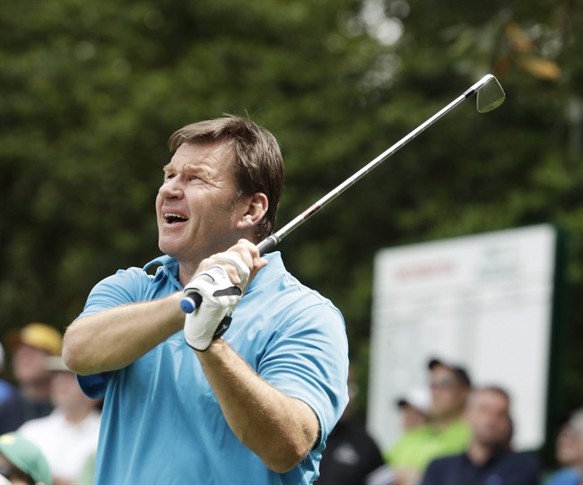 Nick Faldo watches his tee shot on the sixth hole during the par three competition at the Masters golf tournament Wednesday, April 6, 2016, in Augusta, Ga.