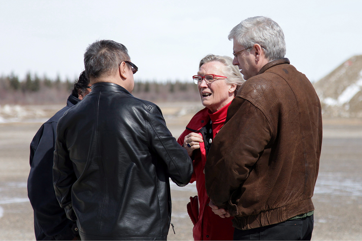 Indigenous Affairs Minister Carolyn Bennett is greeted at the Attawapiskat airport by Chief Bruce Shisheesh on Monday, April 18, 2016, as NDP MP Charlie Angus (right) looks on. 