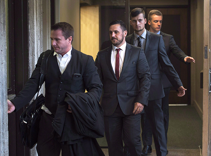 Simon Radford, Joshua Finbow and Craig Stoner, left to right, British sailors charged with sexual assault causing bodily harm while visiting for a hockey tournament earlier in the year, follow lawyer Geoff Newton from Nova Scotia Supreme Court in Halifax on August 12, 2015. 