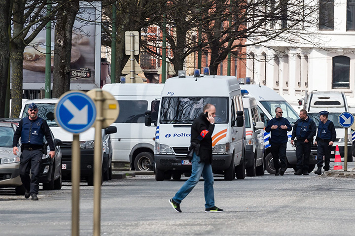 Police secure an area during a house search in the Etterbeek neighbourhood in Brussels on Saturday April 9, 2016. 