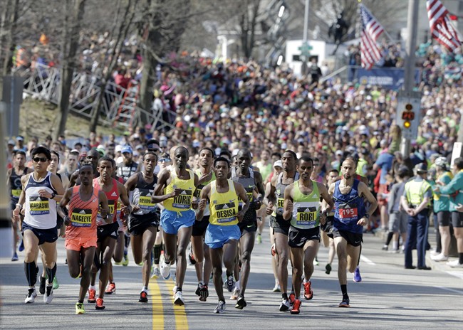 Defending champion Lelisa Desisa, of Ethiopia, center, runs at the head of the pack in the 120th Boston Marathon on Monday, April 18, 2016, in Hopkinton, Mass.